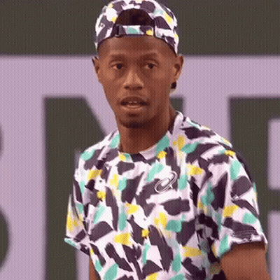 Man In Hat And Colorful Shirt On Tennis Court GIF