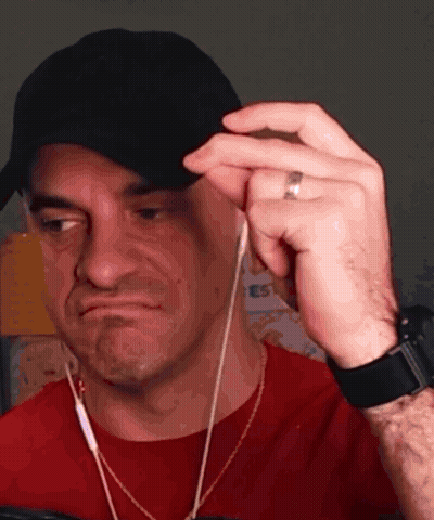 Man In Hat And Earbuds Making A Face GIF