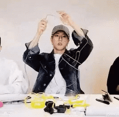 Man In Hat And Glasses At Table With Electronics GIF