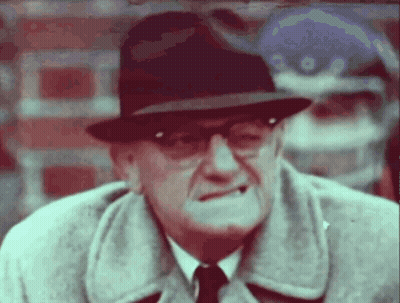Man In Hat And Glasses Looking At Camera GIF