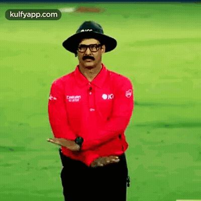 Man In Hat And Glasses Standing With Arms Crossed GIF