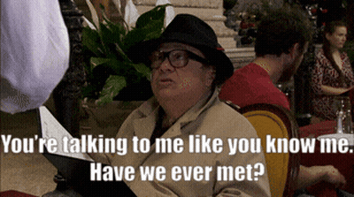 Man In Hat And Glasses Talking At Table GIF