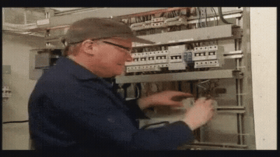 Man In Hat And Glasses Working On Electrical Panel GIF