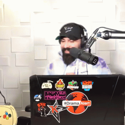 Man In Hat And Headphones In Front Of Microphone With Drama Alert Sticker GIF