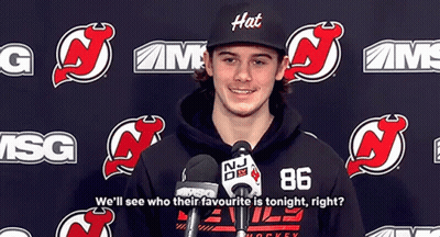 Man In Hat And Hoodie At Microphone GIF