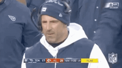 Man In Hat And Hoodie In Front Of NFL Scoreboard GIF