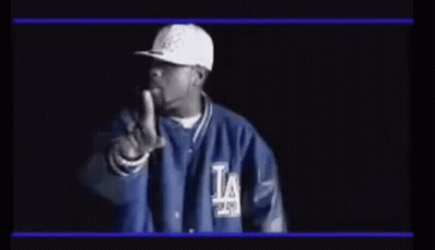Man In Hat And Jacket Pointing At Camera GIF