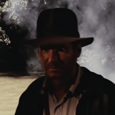 Man In Hat And Jacket Standing In Dark GIF