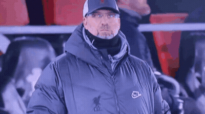 Man In Hat And Jacket Standing In Stands GIF