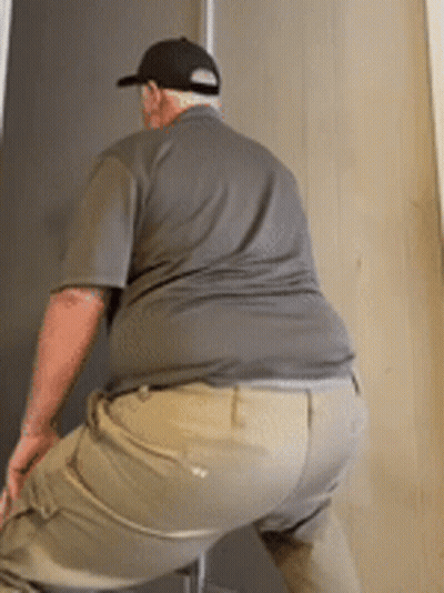 Man In Hat And Khaki Pants Squatting GIF