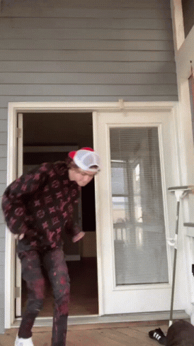 Man In Hat And Louis Vuitton Jacket Standing Before Door GIF