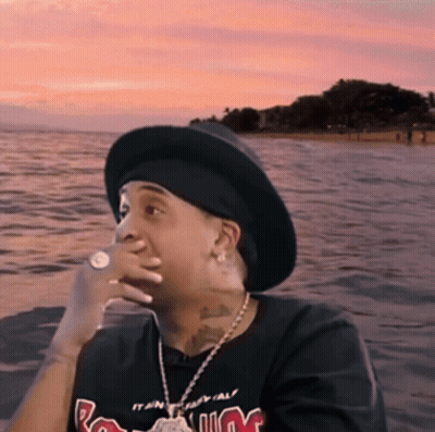 Man In Hat And M T-Shirt Sitting By Water GIF