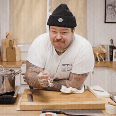 Man In Hat And Matty's Patty's Shirt GIF
