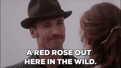 Man In Hat And Mustache Talking To Woman In Field GIF