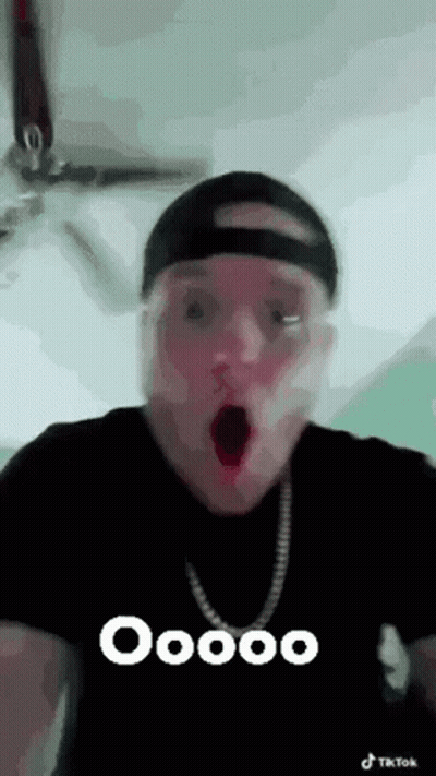 Man In Hat And Necklace Making Funny Face GIF