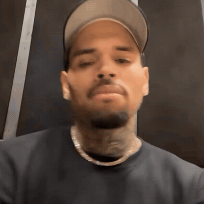 Man In Hat And Necklace Making Funny Face GIF
