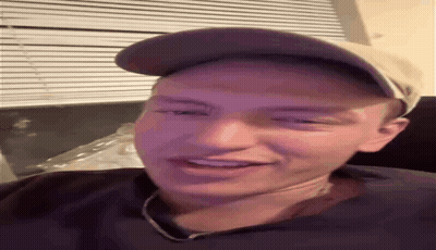 Man In Hat And Necklace Smiling GIF
