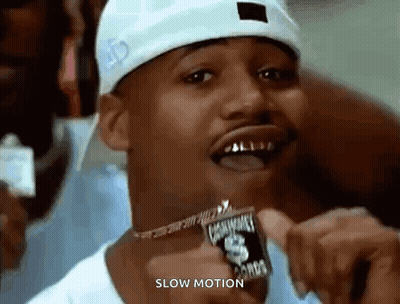 Man In Hat And Necklace Smiling Slow Motion GIF
