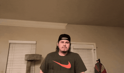 Man In Hat And Nike Shirt Near Cat Tree GIF
