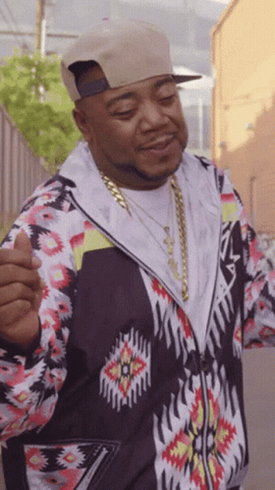 Man In Hat And Patterned Jacket Giving Thumbs Up GIF