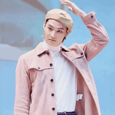 Man In Hat And Pink Jacket Holding Hand To Head GIF
