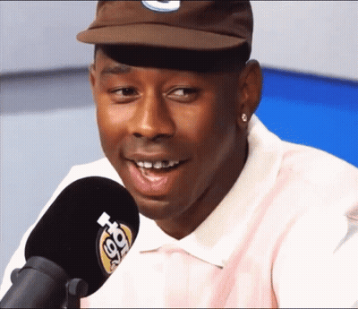 Man In Hat And Pink Shirt Talking Into Microphone 98.7 FM GIF