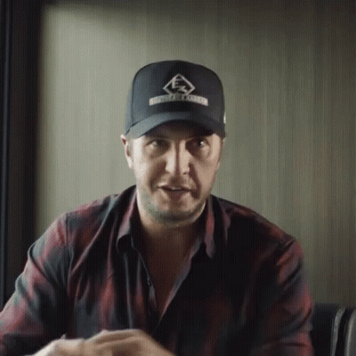 Man in Hat and Plaid Shirt Sitting