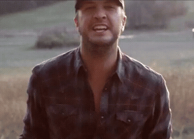 Man In Hat And Plaid Shirt Smiling In Field GIF