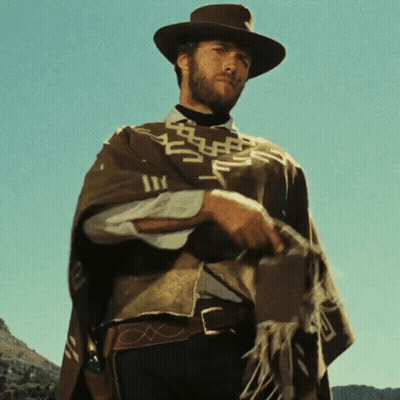 Man In Hat And Poncho Holding Gun GIF