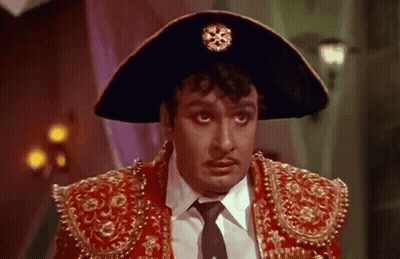 Man In Hat And Red Jacket Looking At Camera GIF