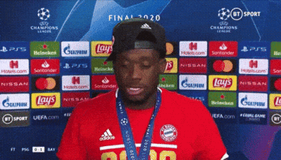 Man In Hat And Red Shirt In Front Of Lays And Nissan Ads GIF
