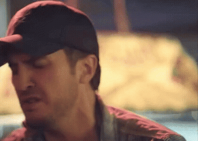 Man In Hat And Red Shirt Looking GIF