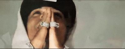 Man In Hat And Rings Praying GIF
