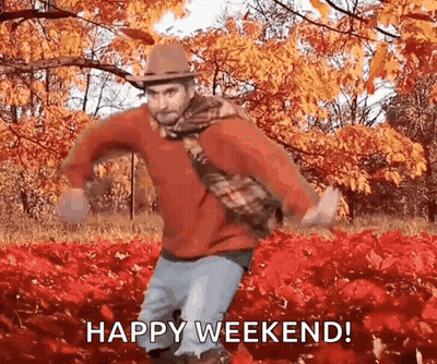 Man In Hat And Scarf Dancing In Leaves Says Happy Weekend GIF