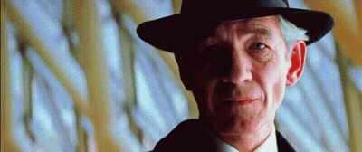 Man In Hat And Suit Looking Sideways GIF