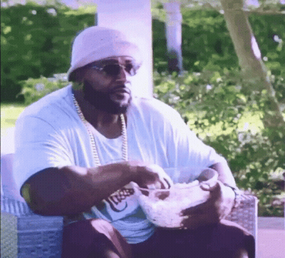 Man In Hat And Sunglasses Eating Bowl Of Food On Couch GIF