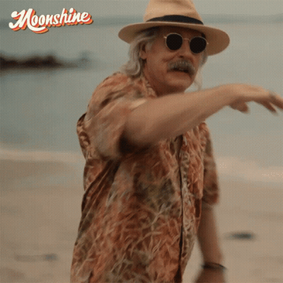 Man In Hat And Sunglasses On Beach With Moonshine GIF