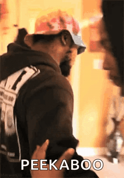 Man In Hat And Sunglasses Says Peekaboo GIF