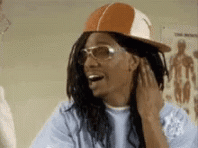 Man In Hat And Sunglasses Smiling Touching Hair GIF