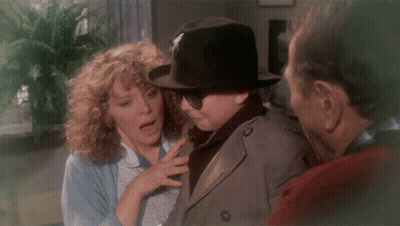 Man In Hat And Sunglasses Talks To Woman And Trench Coat Man GIF