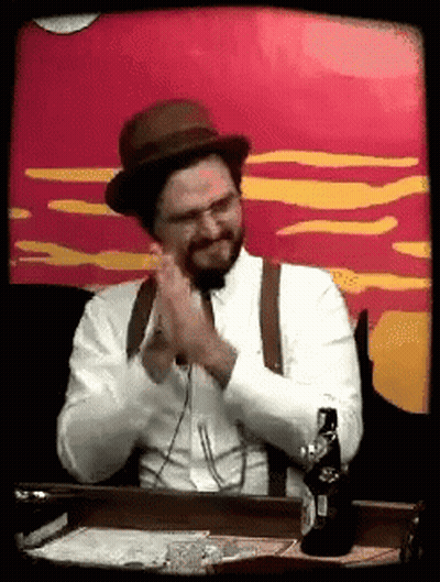 Man In Hat And Suspenders Sitting With Beer GIF
