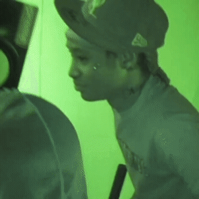 Man In Hat And T-Shirt In Front Of Green Wall GIF