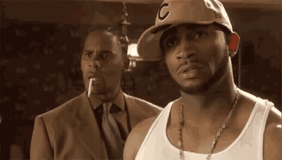 Man In Hat And Tank Top Next To Man In Suit And Tie GIF