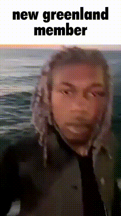 Man In Hat And Tie Standing Before Ocean Saying New Greenland Member GIF