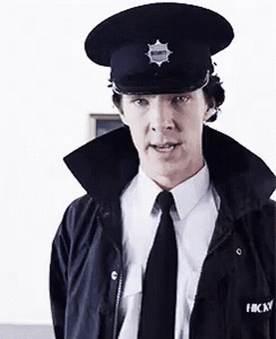Man In Hat And Tie Standing In Room GIF