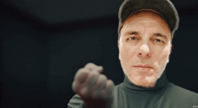 Man In Hat And Turtleneck Pointing GIF