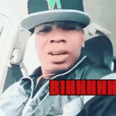 Man In Hat And Vest In Car With Red Bihhhh GIF