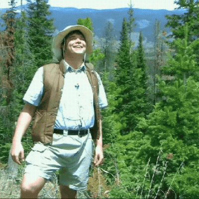 Man In Hat And Vest In Forest GIF
