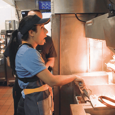 Man In Hat And Visor In Front Of McDonald's Display At 5:00 GIF