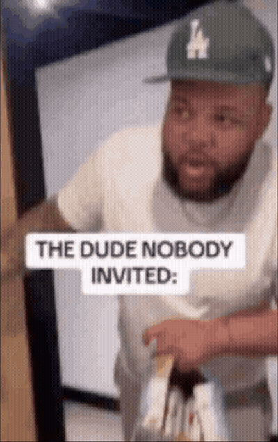 Man In Hat And White Shirt Holding Wine GIF